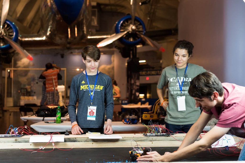 Kinvert Mentor students troubleshooting their robots in preparation for Maker Faire Detroit