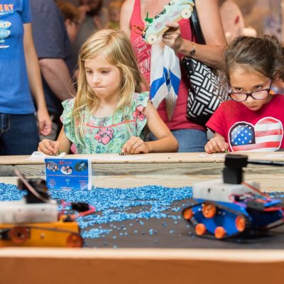 STEM girls focused on driving construction robots made in 3D Printing Robotics and Coding Class