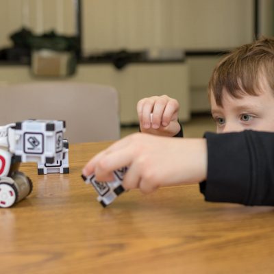 As part of our Anki Cozmo Robotics Competition Summer Camp for Kids and Teens a student interacts with Cozmo