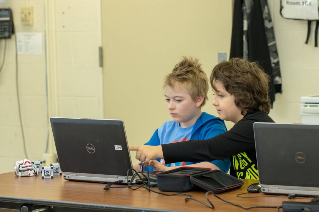 Students programming the Anki Cozmo in Python using the SDK during Summer Robotics Camp for Kids