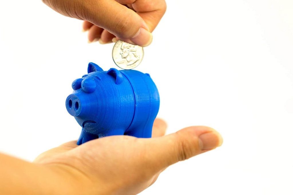 Busness for Kids - Beyond a Lemonade Stand - Class for kids image shows a piggy bank with coin being put in